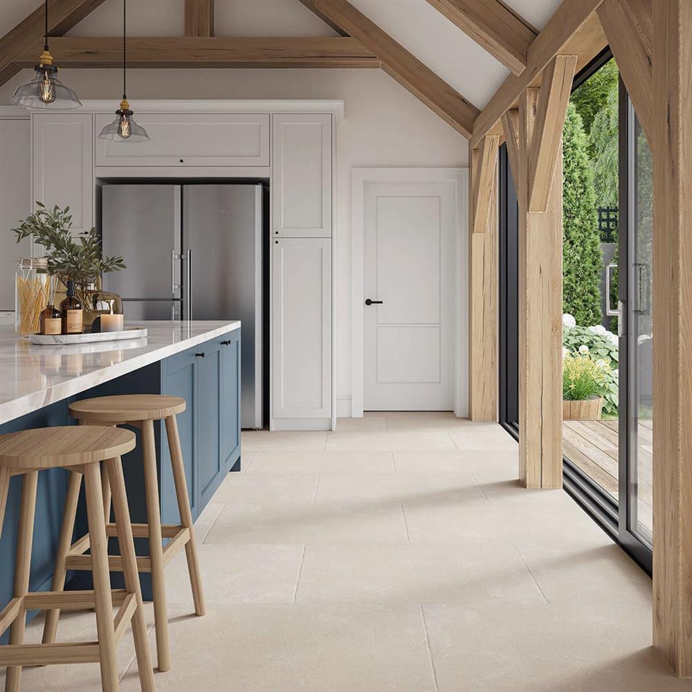 Savoie Blanco antique limestone effect porcelain tiles in a large barn kitchen